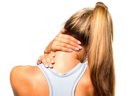 Woman with a blonde ponytail seen from behind, pressing both hands to the back of her neck