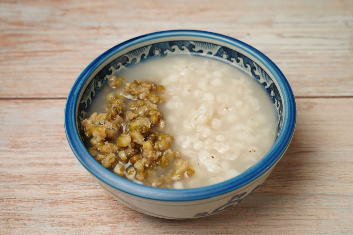 Cooked mung beans and soft white rice side by side in a blue patterned bowl